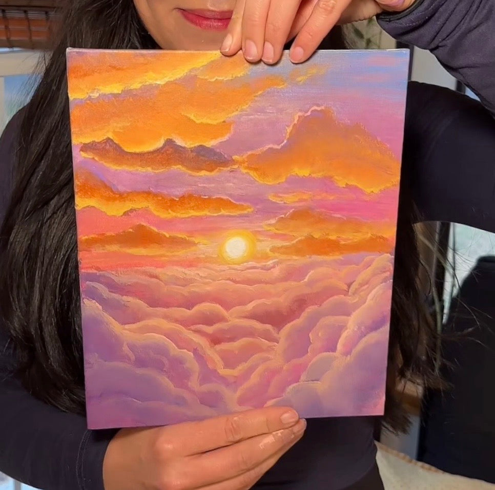 An image of a painting on a wall. The painting is 12 inches by 12 inches and features a a sky full of clouds with the sun peeking through them.